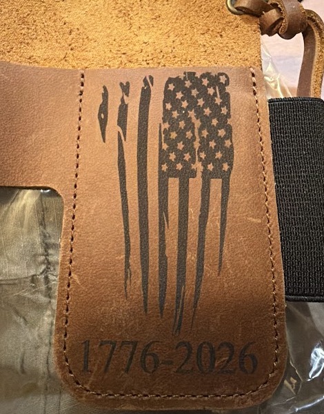 Tan leather knife case engraved with a distressed American flag and 1776-2026