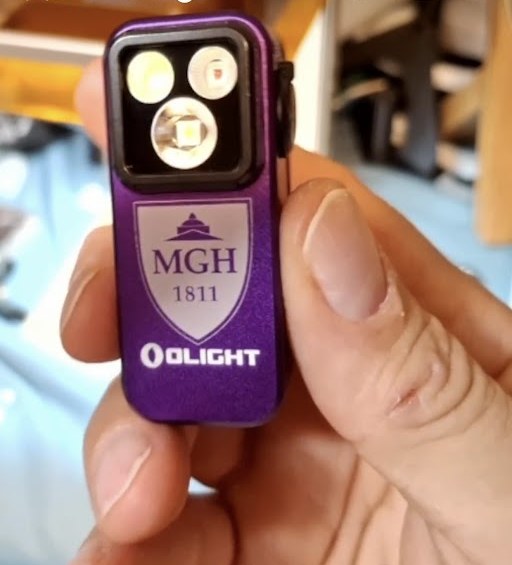 Purple Olight Oclip with a custom MGH 1811 shield crest laser engraved in white