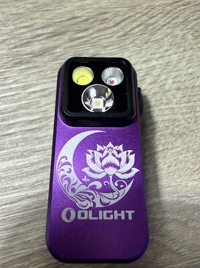 Purple Olight Oclip laser engraved with a crescent moon and ornate lotus flower design