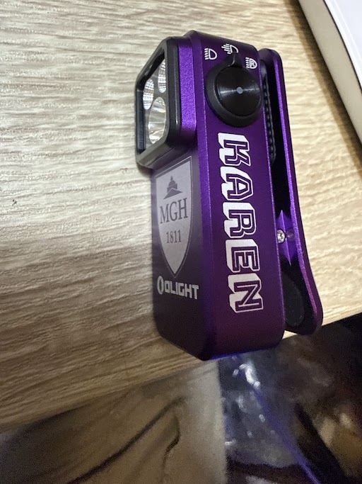 Purple Olight Oclip with the name Karen laser engraved in block letters down the side