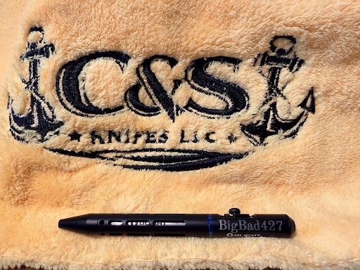 Black Olight O-Pen Mini 2 laser engraved with BigBad427, displayed on a C&S Knifes LLC embroidered blanket