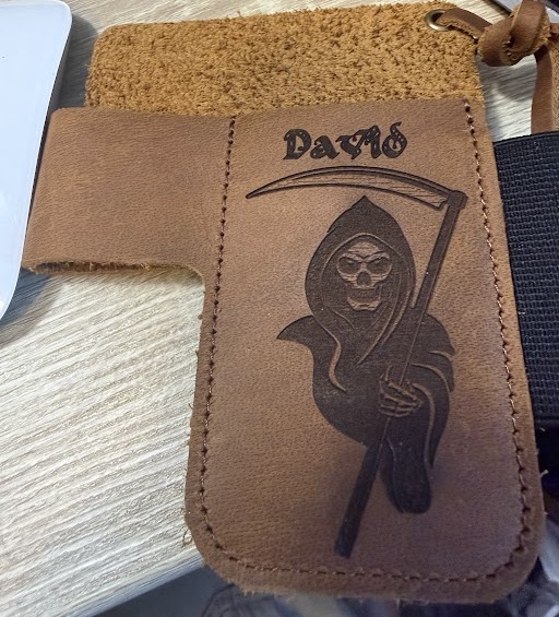 Tan leather knife case engraved with the name David in Old English lettering above a Grim Reaper
